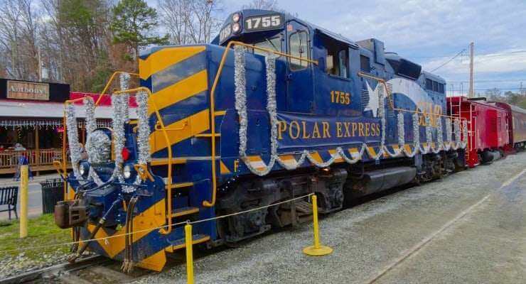 1. Vintage Polar Express train decorated for Smoky Fans event, vibrant blue and yellow colors.